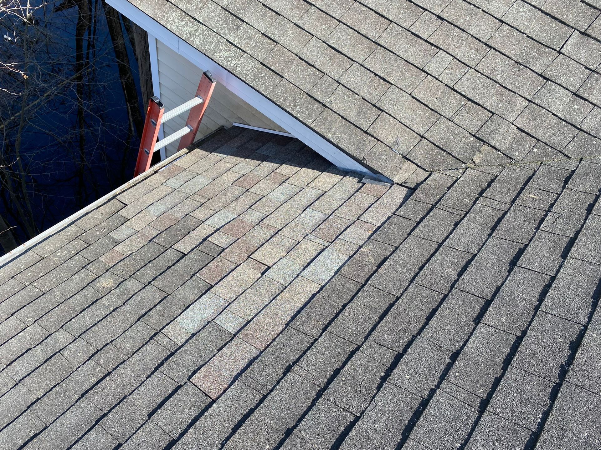 A close up of a roof with a ladder on it.