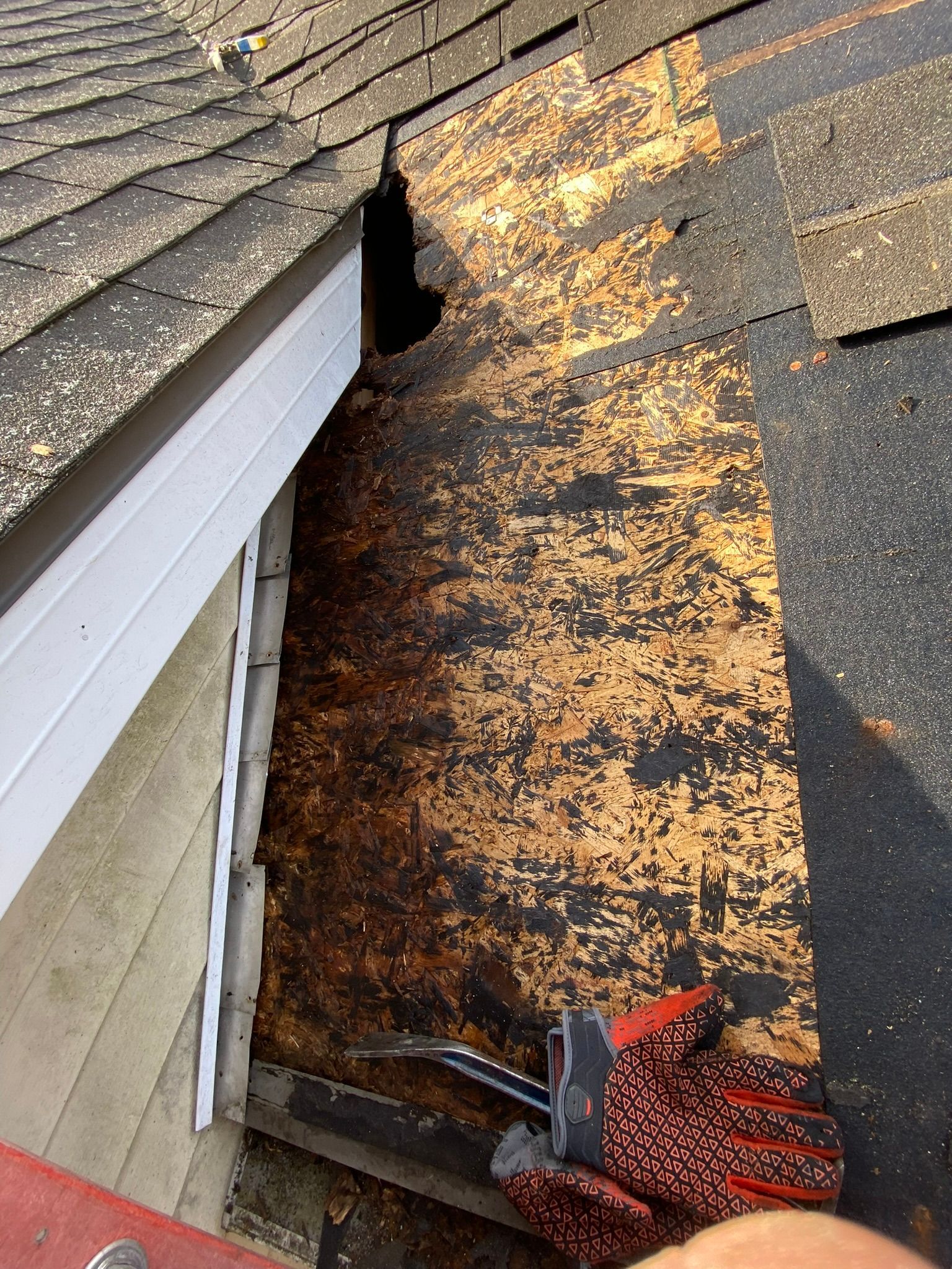 A person is working on the roof of a house.