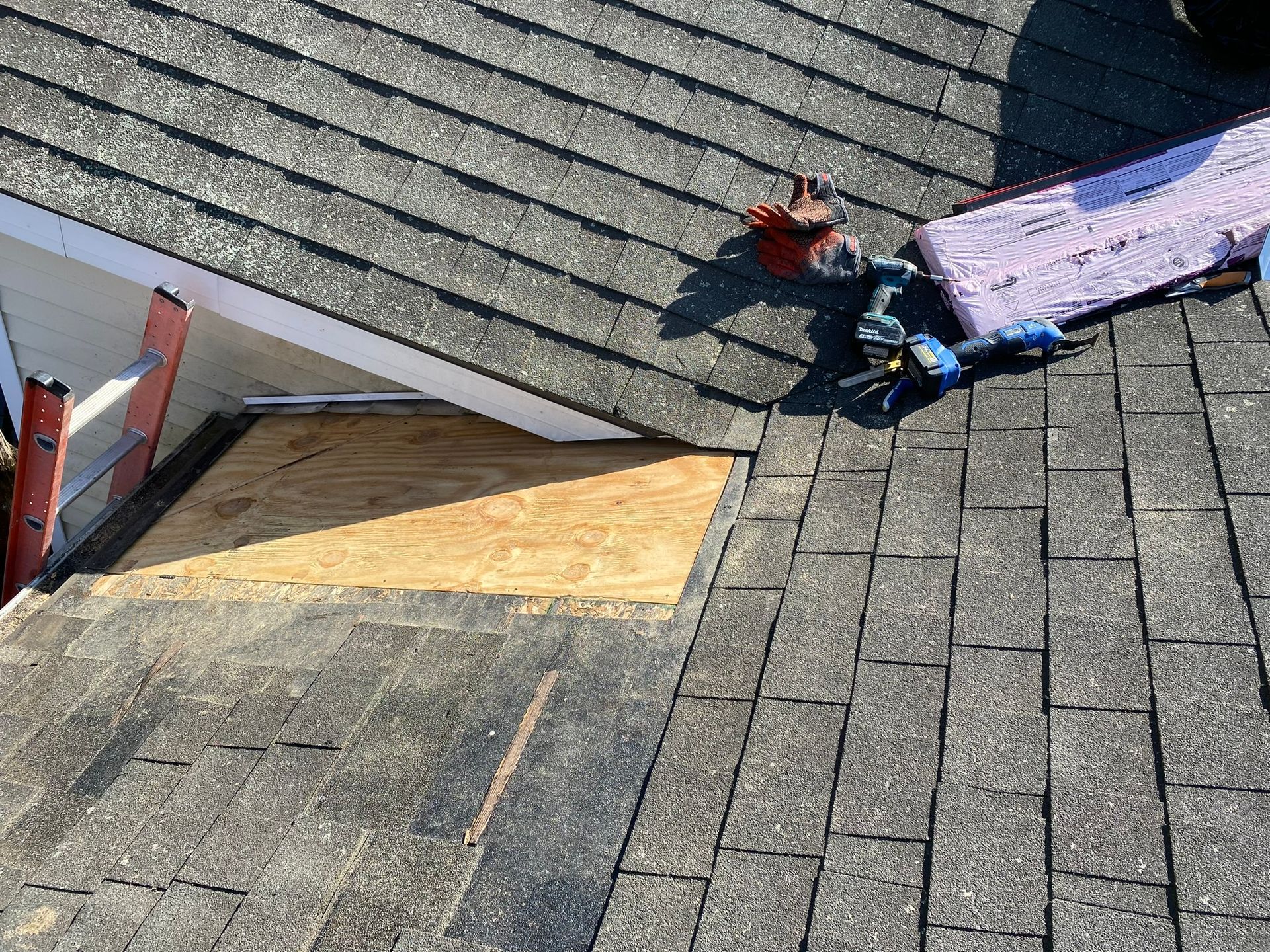 A roof with a hole in it is being repaired.