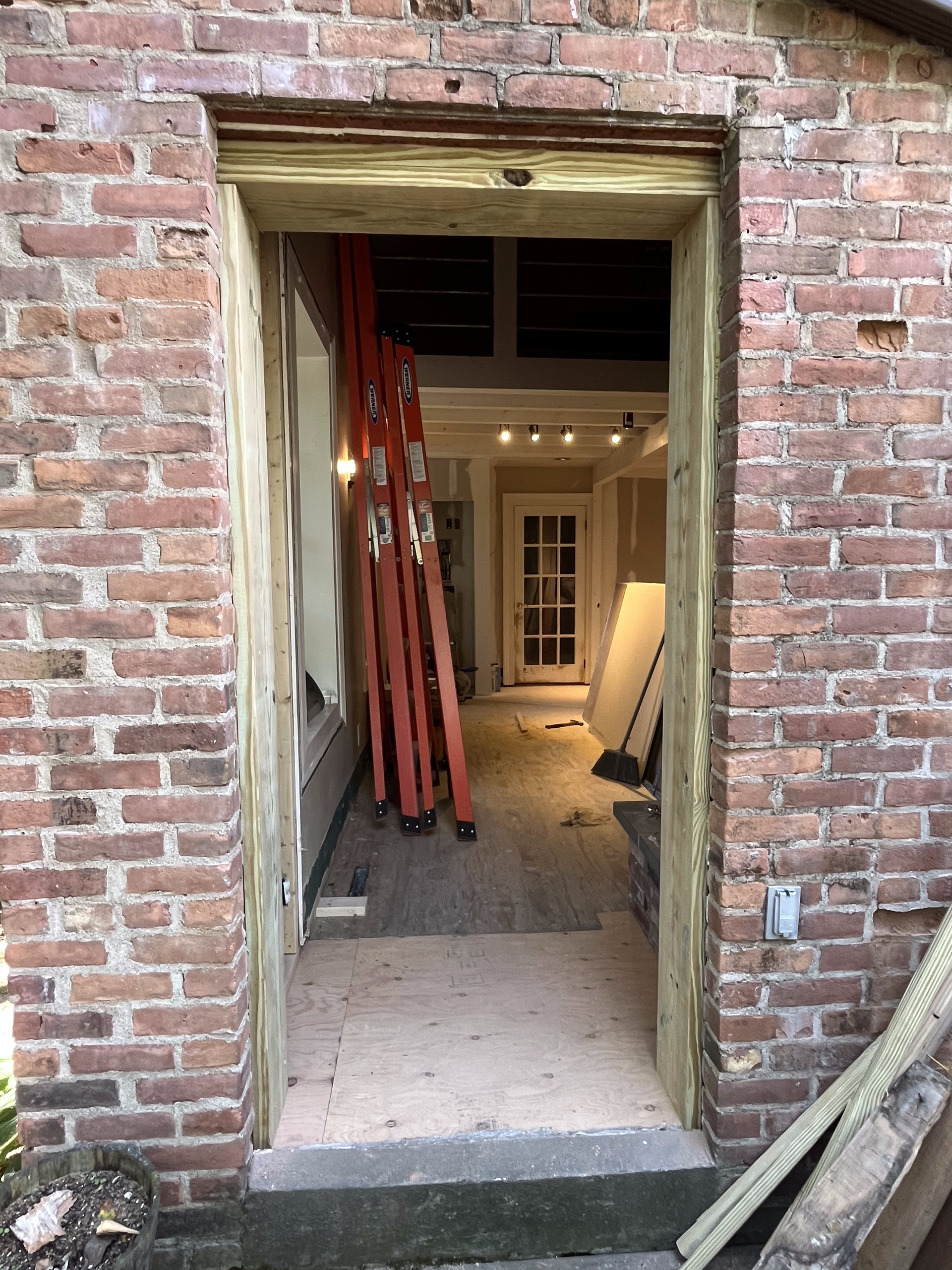 A brick wall with a wooden frame around it