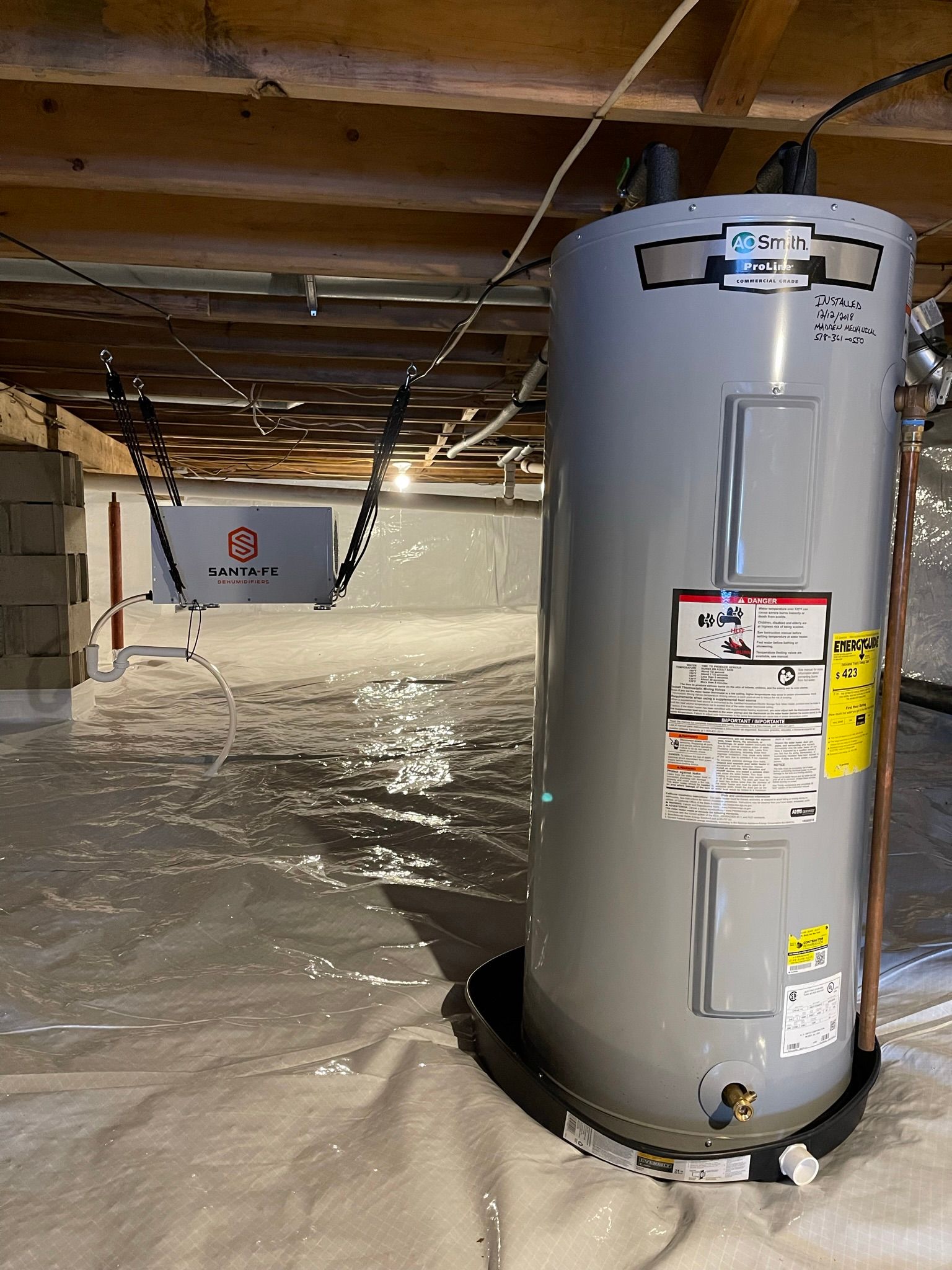 A water heater is sitting in a flooded basement.