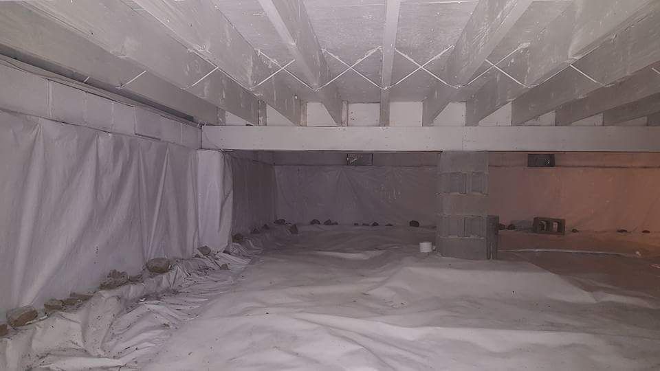 A very large room with a lot of white sheets on the floor.