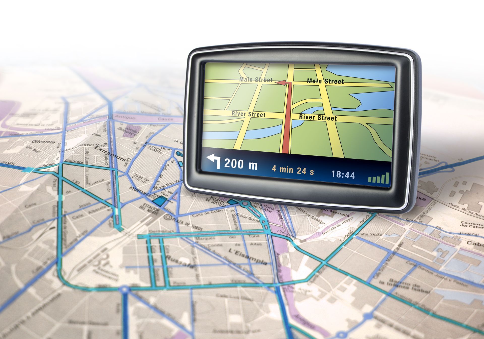 A gps device is sitting on top of a map
