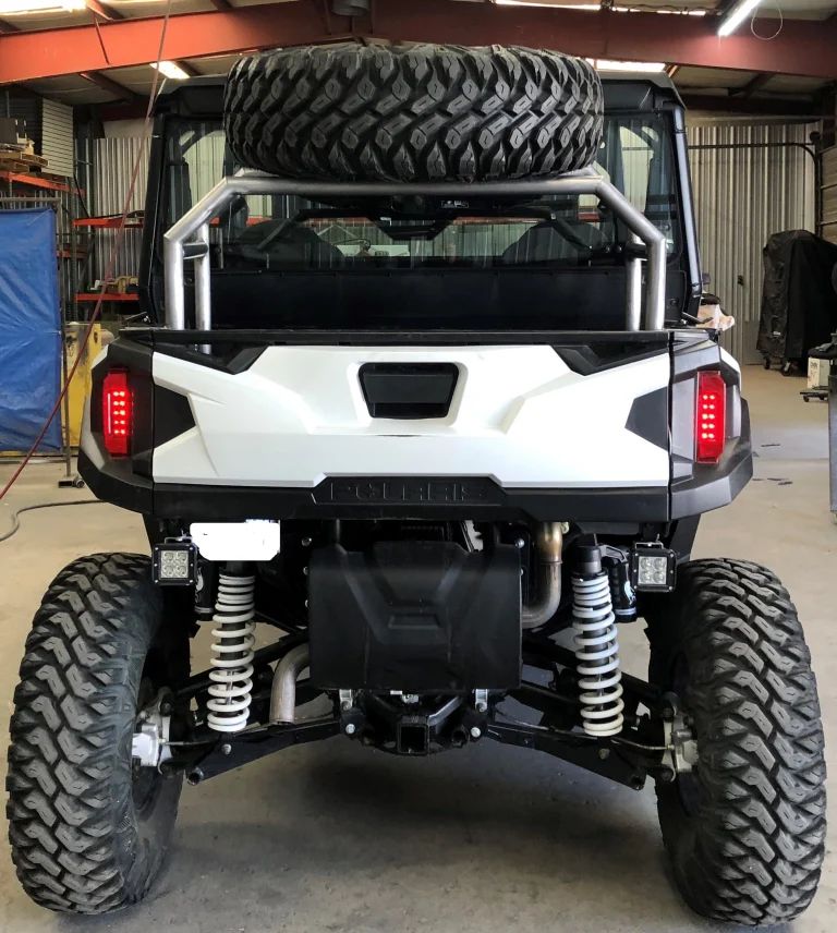 A White ATV With Big Tire on the Hood - Trucks Unique