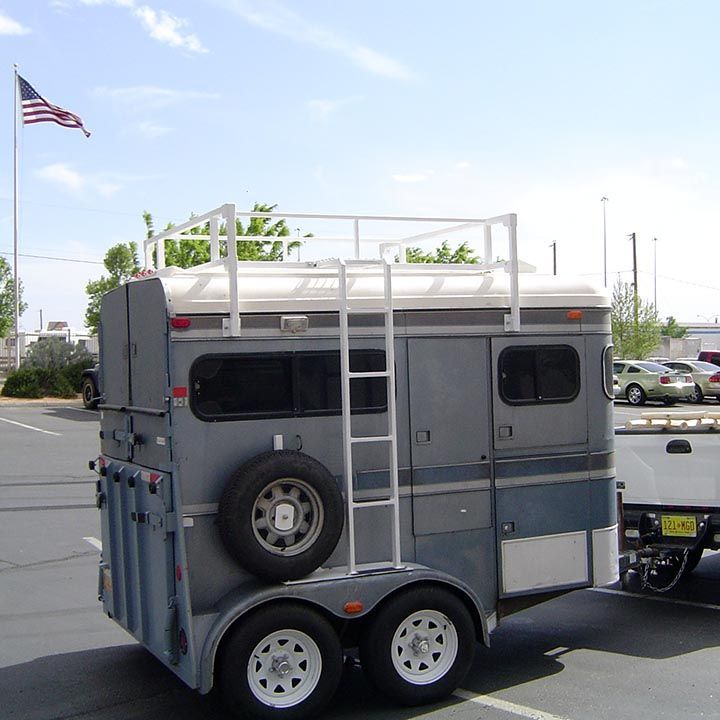 A Horse Trailer With a Ladder Attached to it is Parked in a Parking Lot - Truck Unique