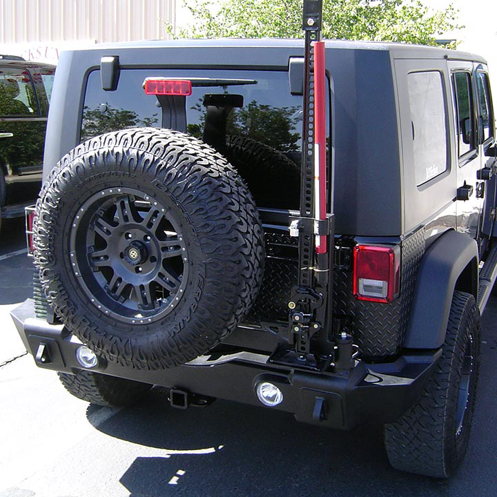 A Black Jeep With Big Tire on His Back - Truck Unique