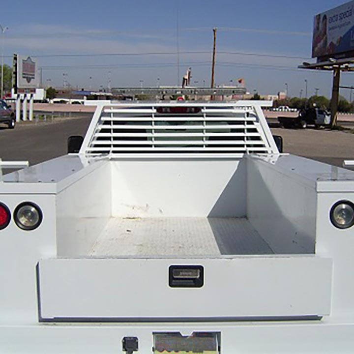 A White Truck is Parked in Front of a Billboard that Says Acdelco - Truck Unique