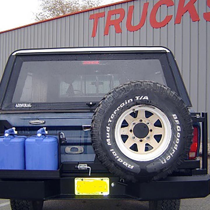 A Jeep is Parked in Front of a Building that Says Trucks - Truck Unique