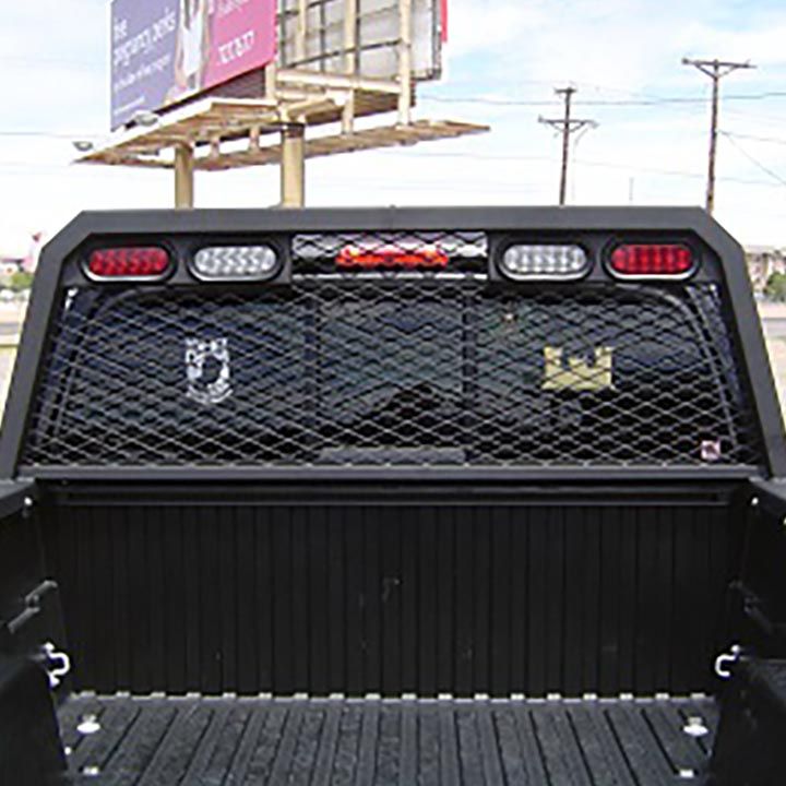 The Back of a Black Truck With a Billboard in the Background - Truck Unique