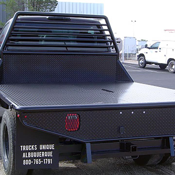 A Black Truck With a Flat Bed is Parked in a Parking Lot - Truck Unique