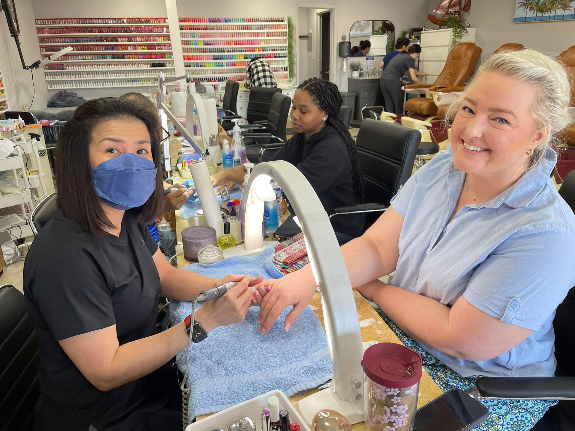 A shelf filled with bottles of nail polish of different colors.