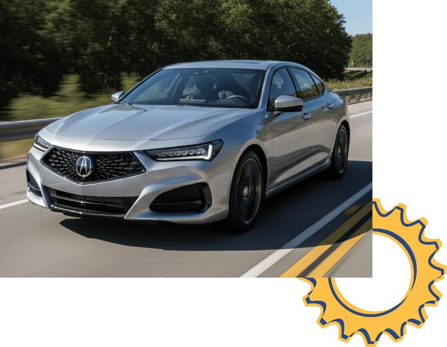 Acura TLX sedan driving on highway surrounded by trees.