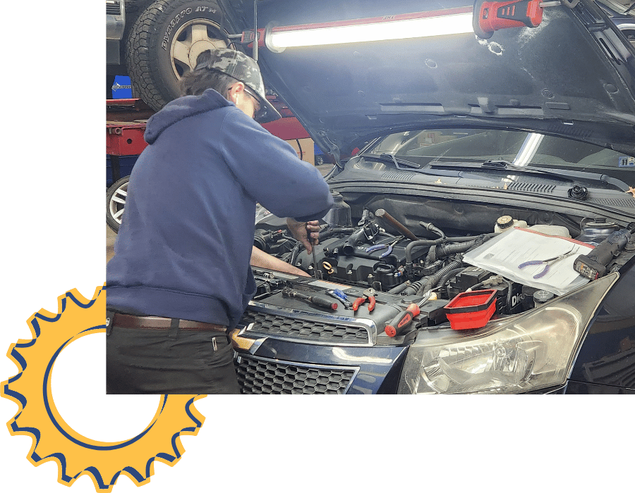 Mechanic repairing engine components under the hood during alternator service.