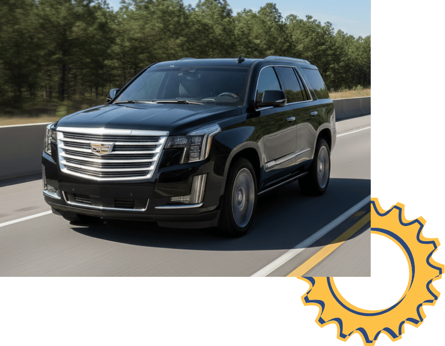 Cadillac Escalade SUV driving on highway with forest background.