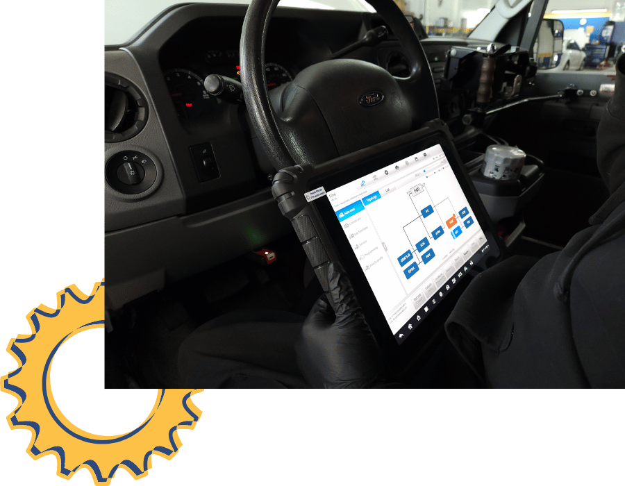 Technician reviewing diagnostic data on a tablet connected to a vehicle for check engine light service.