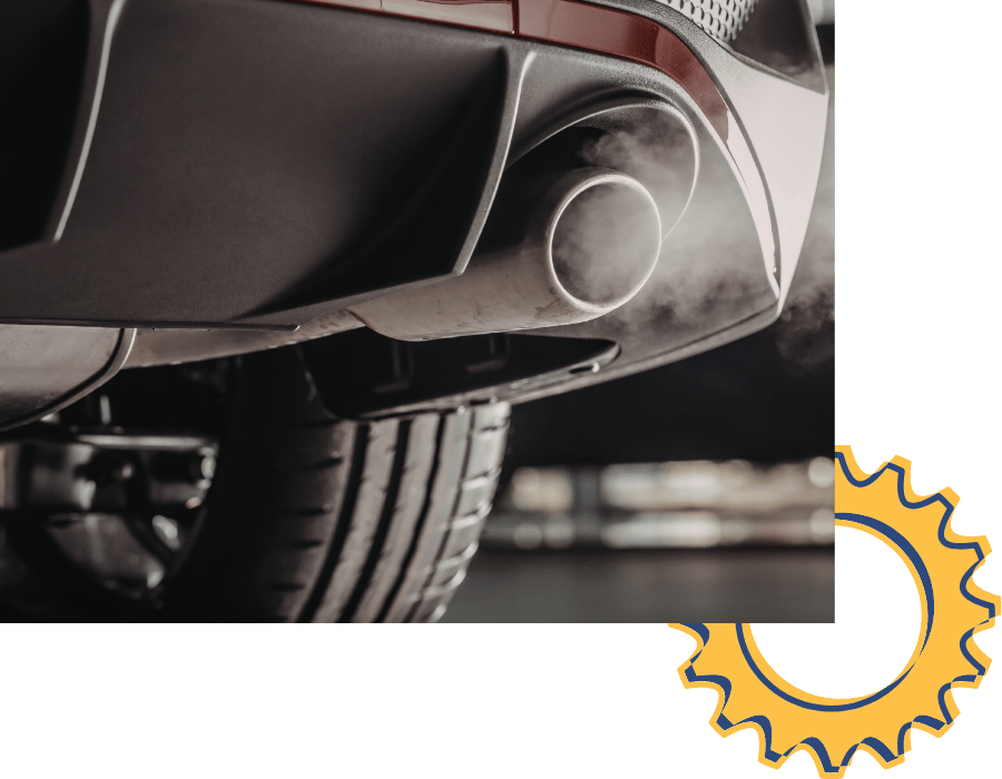 Vehicle exhaust pipe emitting visible exhaust during emissions and exhaust service.