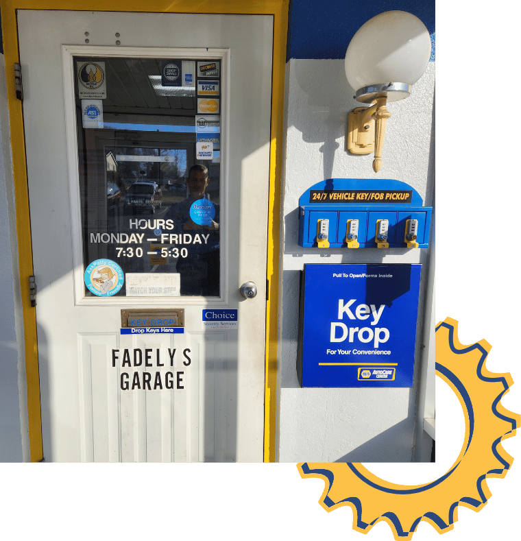 Front door of Fadely's, with key drop box, and operating hours sign. Yellow trim, exterior.