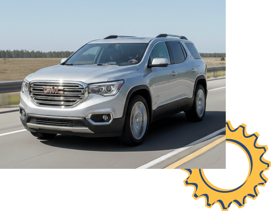 GMC Acadia SUV driving on open road.