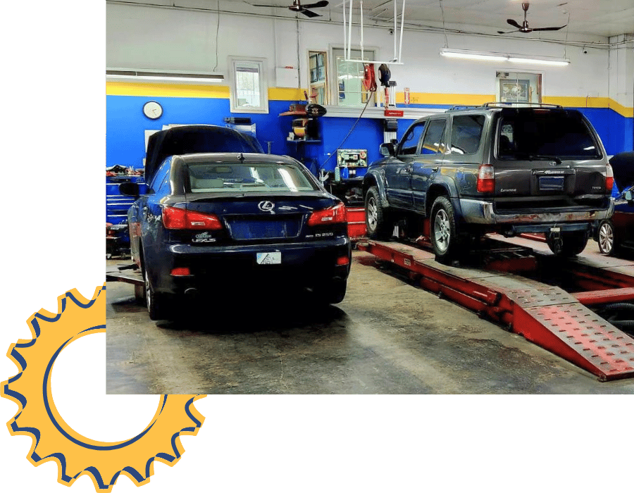 Lexus IS sedan and Toyota SUV positioned on alignment racks inside service bay.