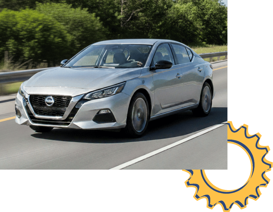 Nissan Altima sedan driving on open road.