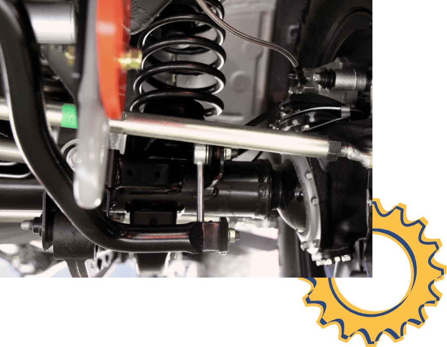 Close-up of suspension components including coil spring and control arm.