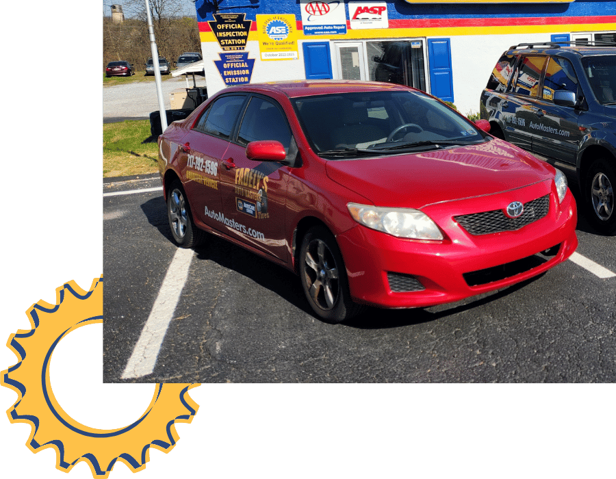 Red Toyota Corolla service vehicle parked outside Fadely&rsquo;s Auto Masters.