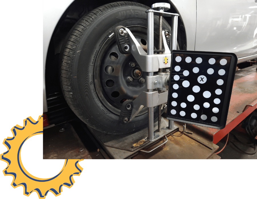 Wheel alignment equipment attached to a vehicle tire during an alignment service.