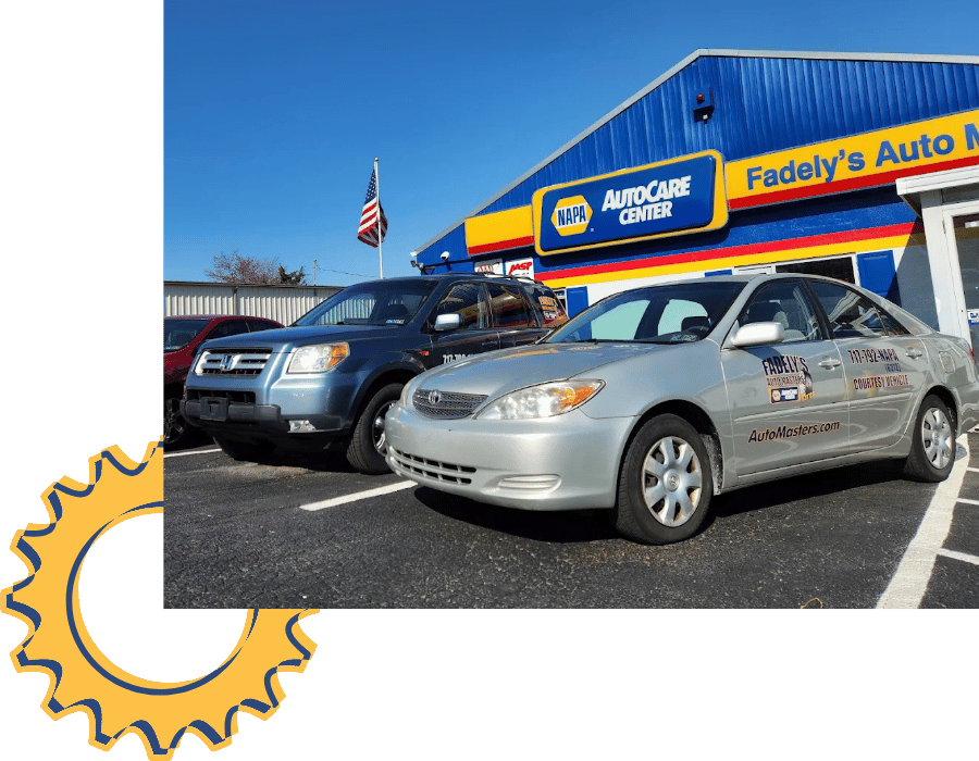 Fadely&rsquo;s Auto Masters service vehicles parked outside NAPA AutoCare Center.