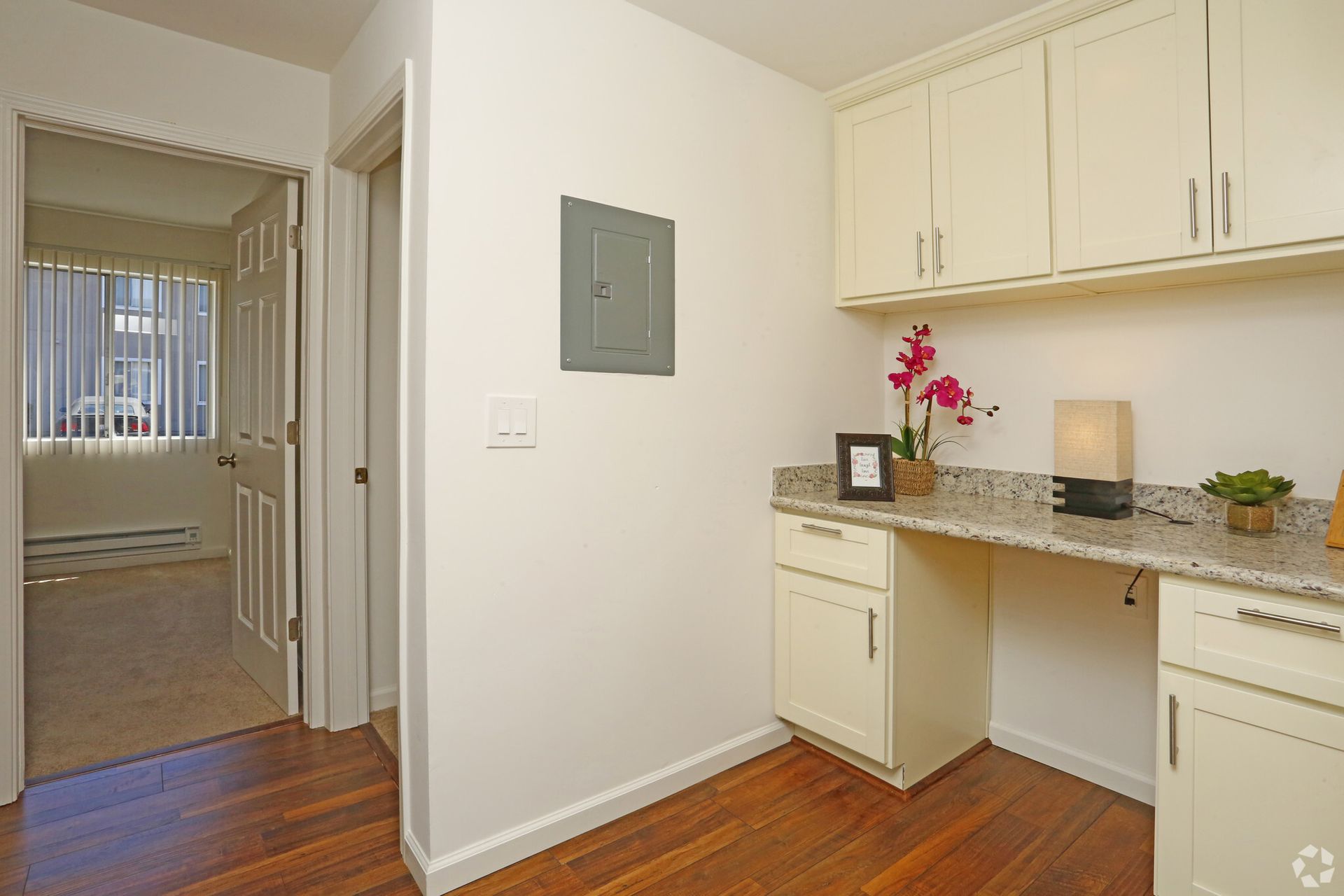 A room with a desk and cabinets in it