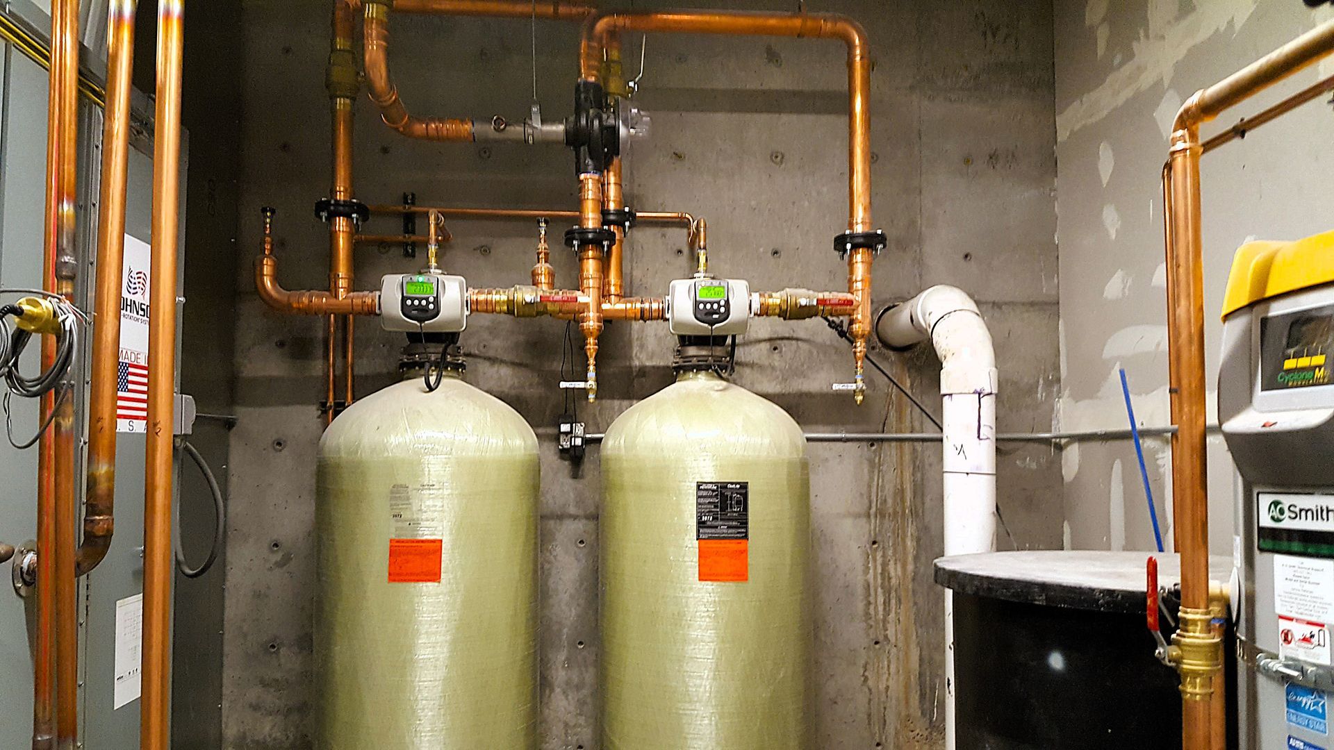 Expert plumbing repair removing mineral scale from drain line in Draper UT kitchen, restoring flow with Sharp Water Solutions