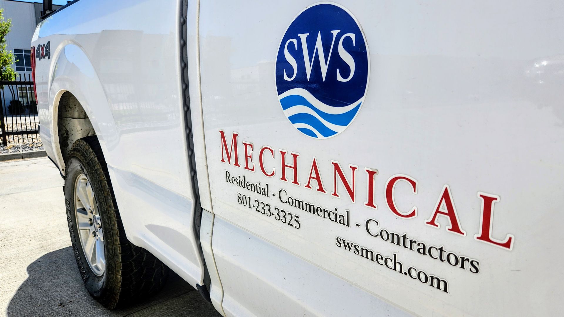 Cropped Shot Of Woman's Hand Filling A Glass Of Filtered Water— Bluffdale, UT — Sharp Water Solutions SWS Mechanical - Side of truck door