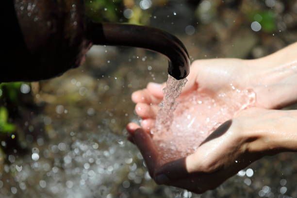 Hands of Woman Scooping Water— Bluffdale, UT — Sharp Water Solutions