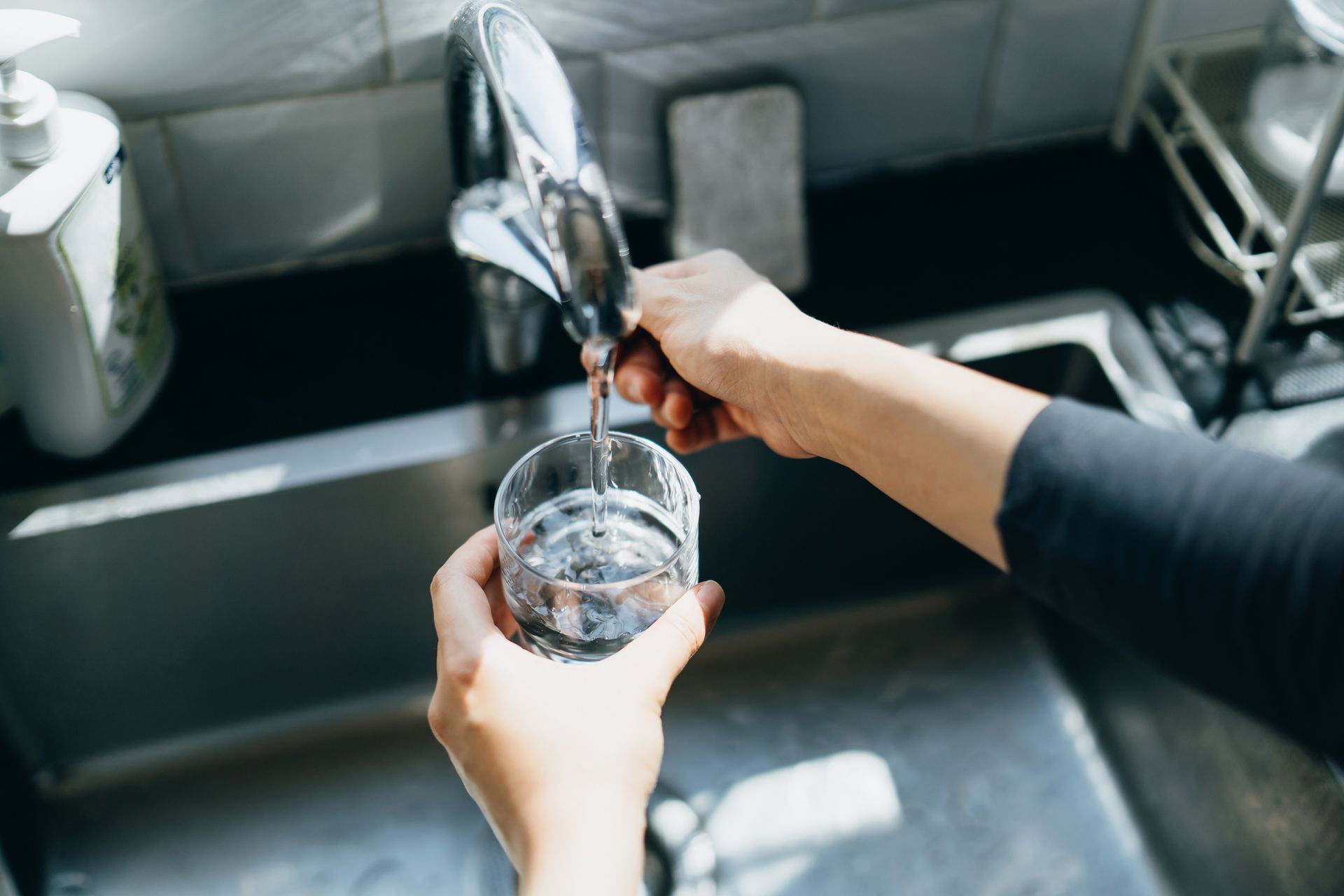 Cropped Shot Of Woman's Hand Filling A Glass Of Filtered Water — Bluffdale, UT — Sharp Water Solutions