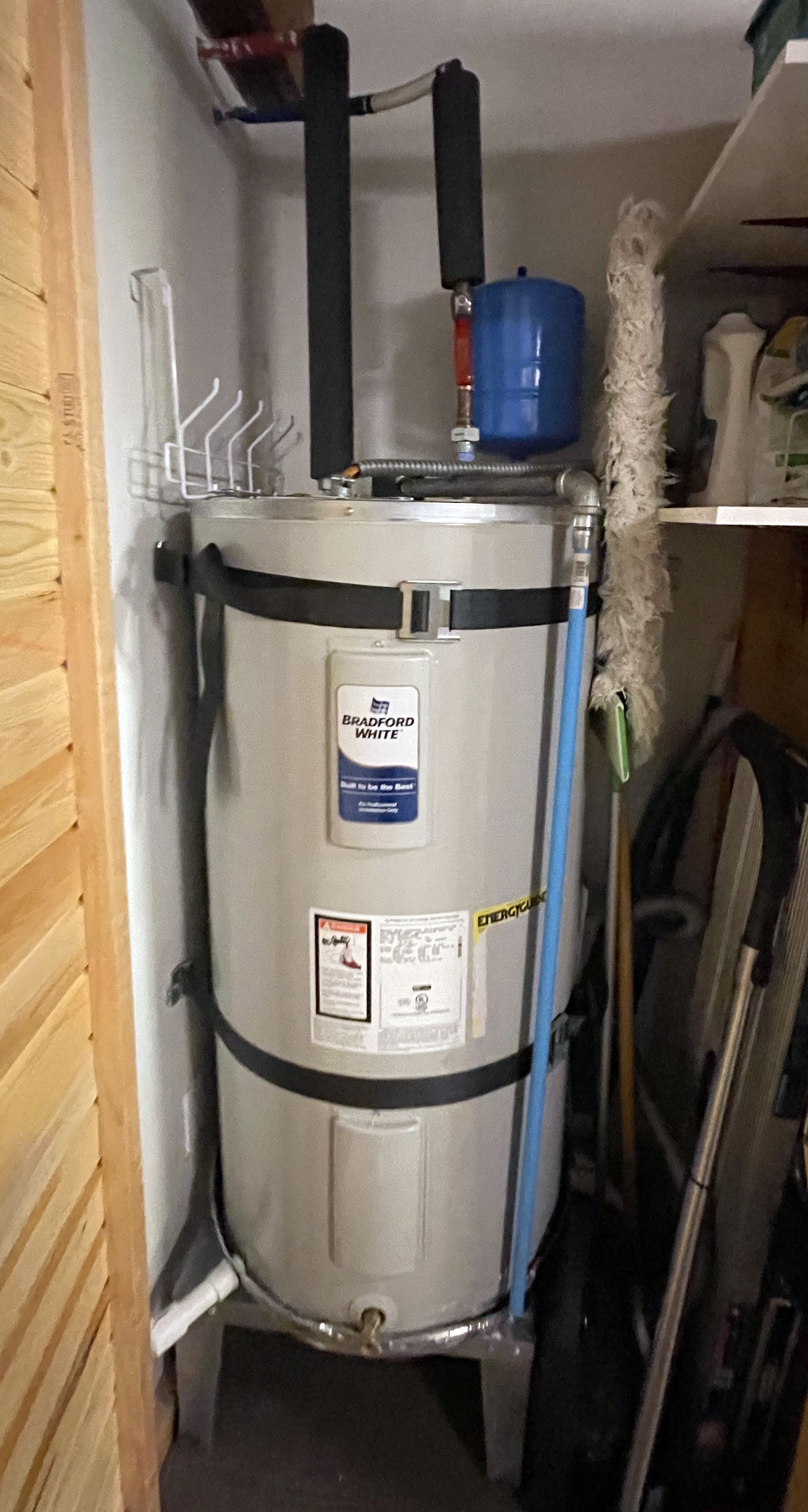 Sharp Water Solutions installing water heater replacement in Tooele County residential utility closet for reliable hot water.