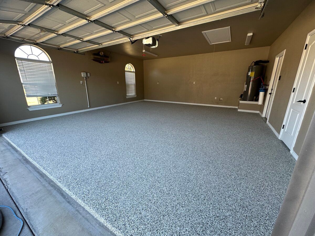 Garage with speckled gray epoxy flooring and tan walls.