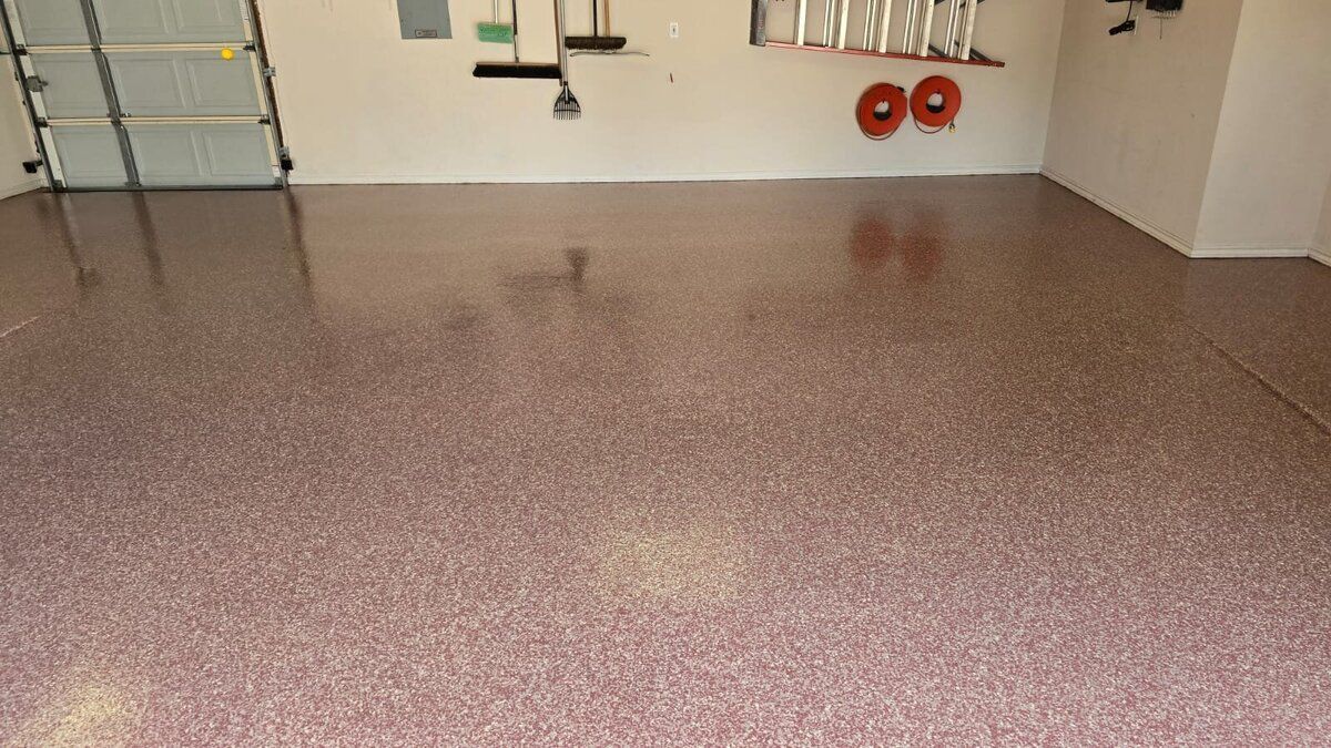 Garage with epoxy floor coating in shades of pink and beige. 
