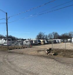 RV and vehicle storage lot on a sunny day.