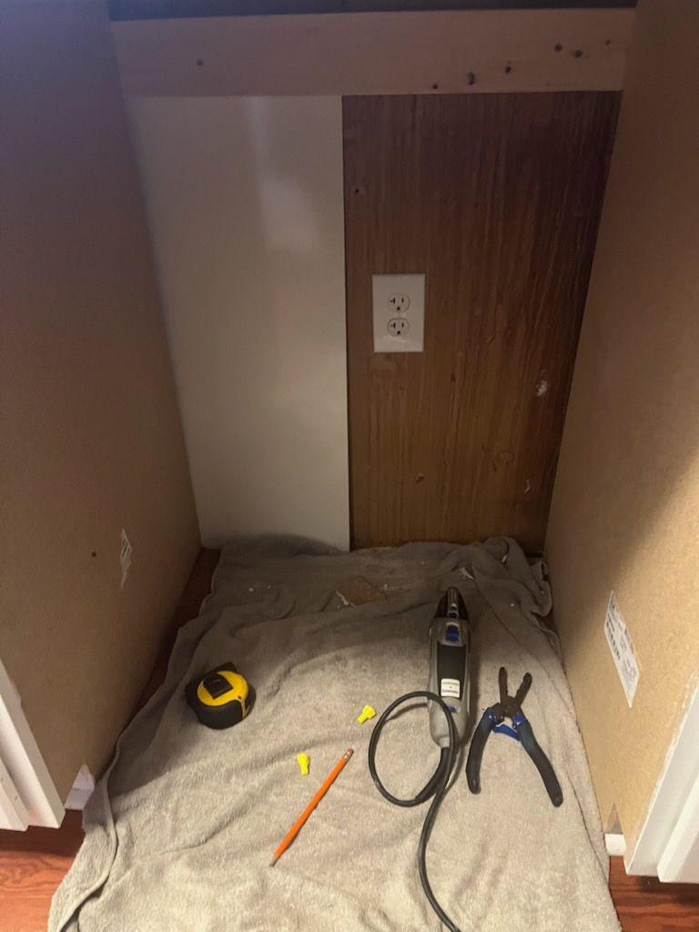 A room with a towel on the floor and tools on the floor.