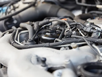 A close up of a rusty diesel particulate filter on a car