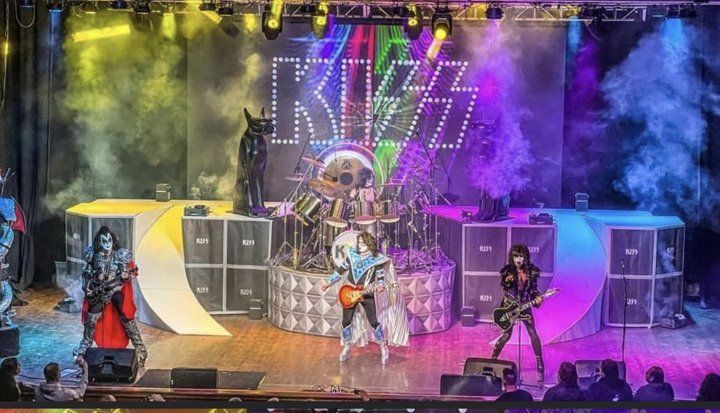 a kiss band is playing a concert on a stage .