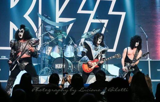 a poster for a community concert with kiss on it .