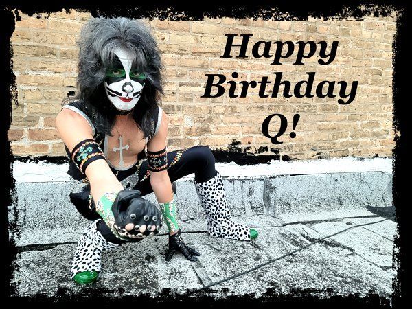 a man in a mask is kneeling down in front of a brick wall and says happy birthday q!