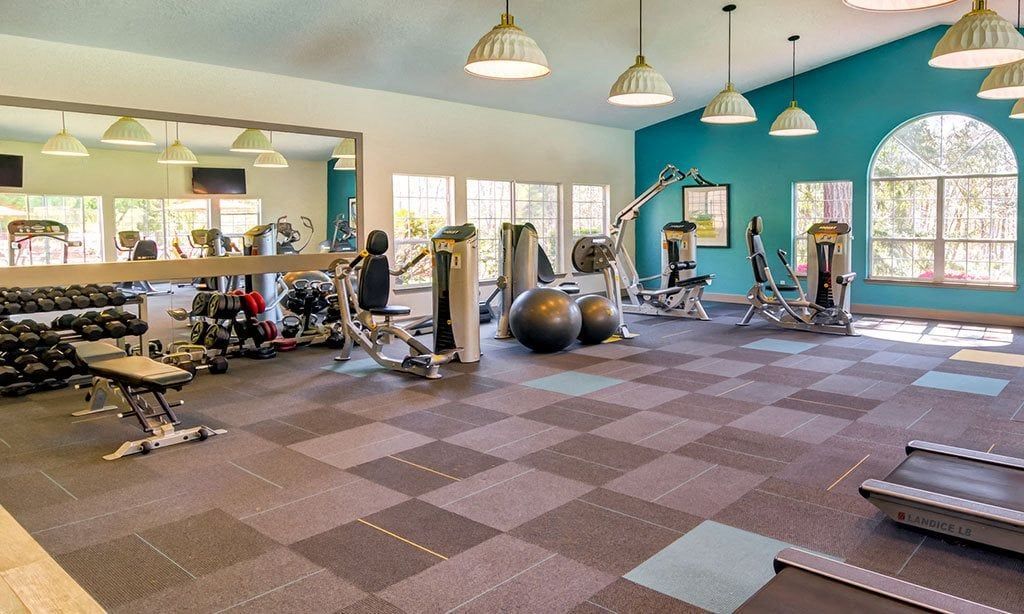Bright fitness center with cardio machines, weights, and exercise balls at Sofi at Murrayhill, offers apartments in Beaverton, OR.
