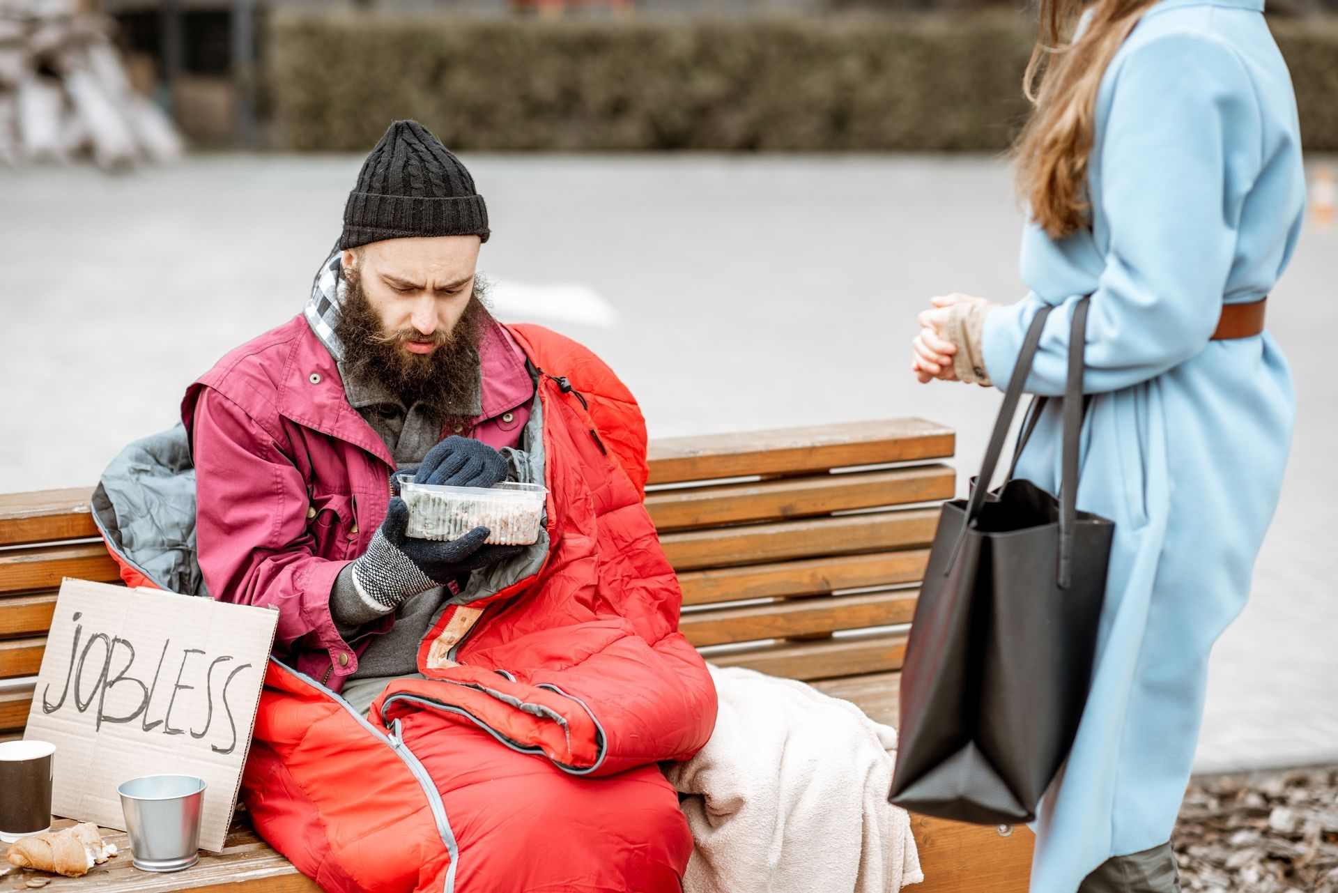 Woman gives hot meal to homeless