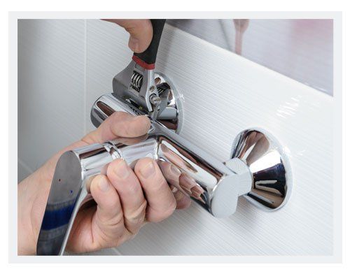 Man's Hands Fixing a Shower Faucet with a Adjustable Wrench — Canberra, ACT — Discount Plumbing Heating & Cooling