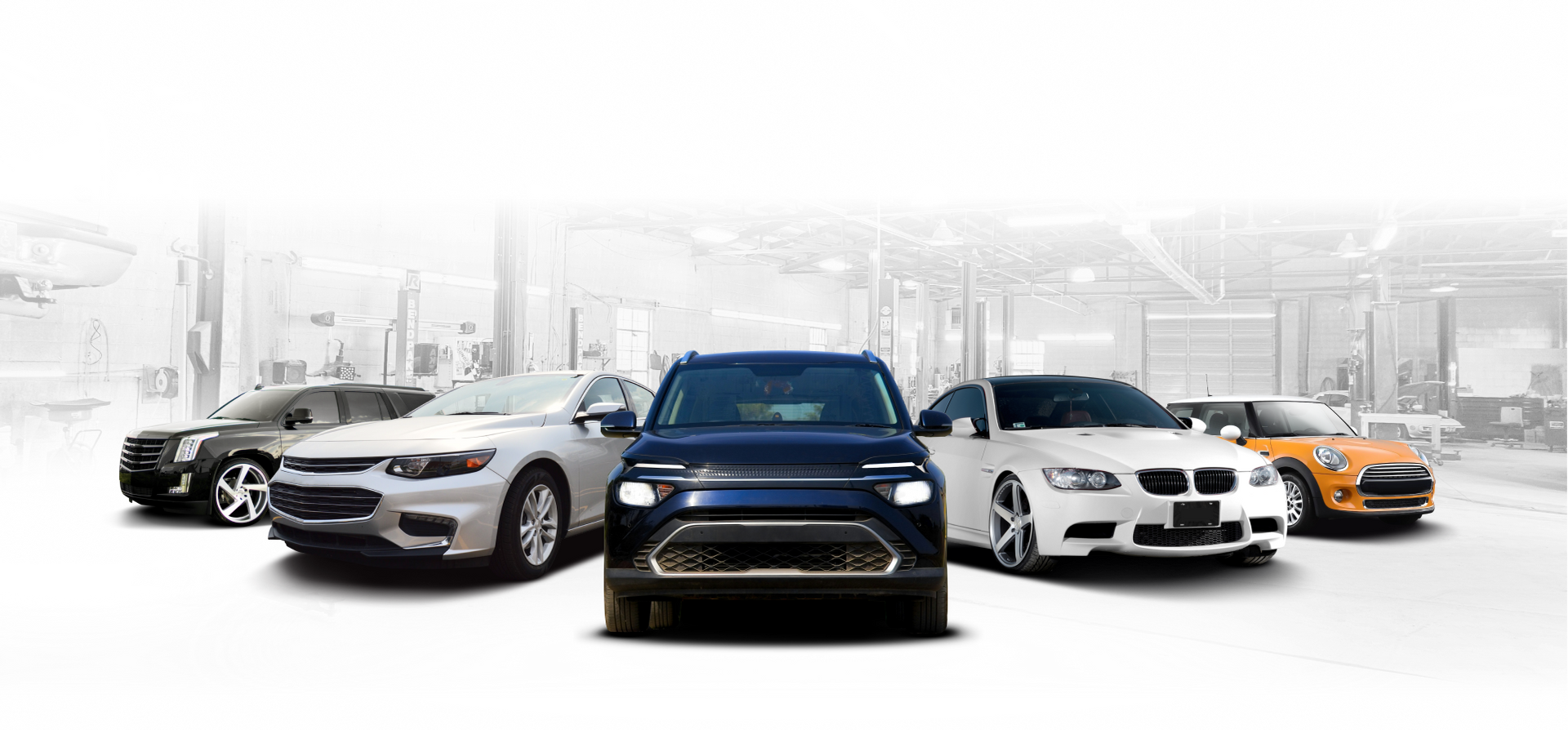 A group of cars are parked next to each other in a garage. | J & J Automotive