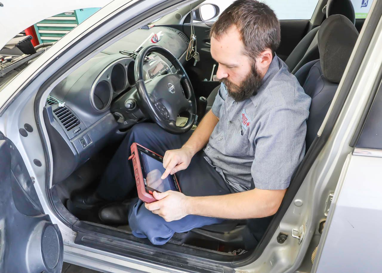 Mechanic Performing Interior Vehicle Diagnostics | Andy's Auto Repair & Tires Inc.