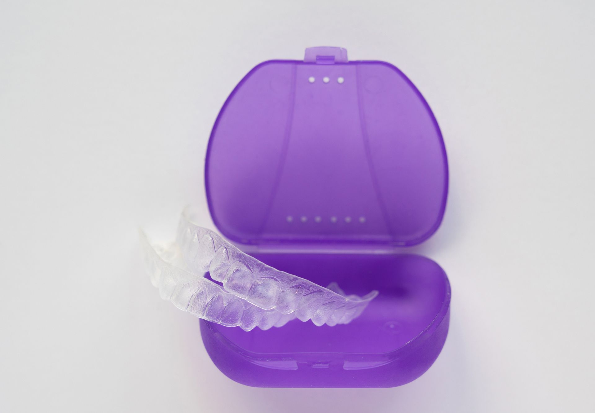A purple case with a clear retainer inside of it
