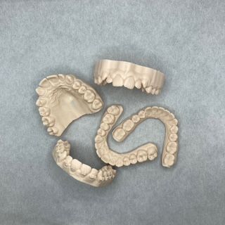 A set of teeth on a blue surface