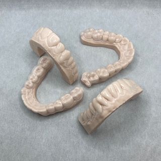 A group of teeth are sitting on top of each other on a table.